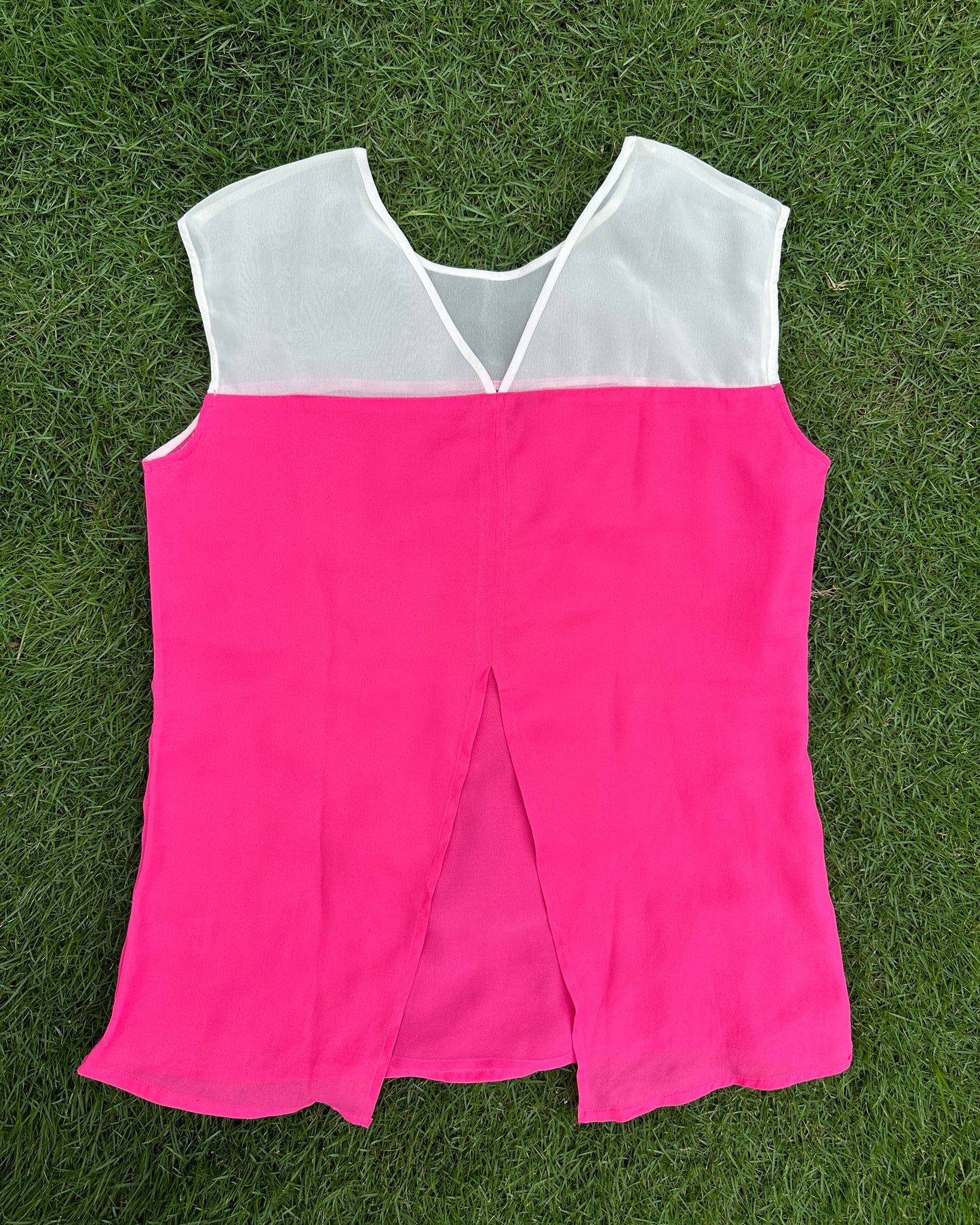 White and pink top with metal eyelets