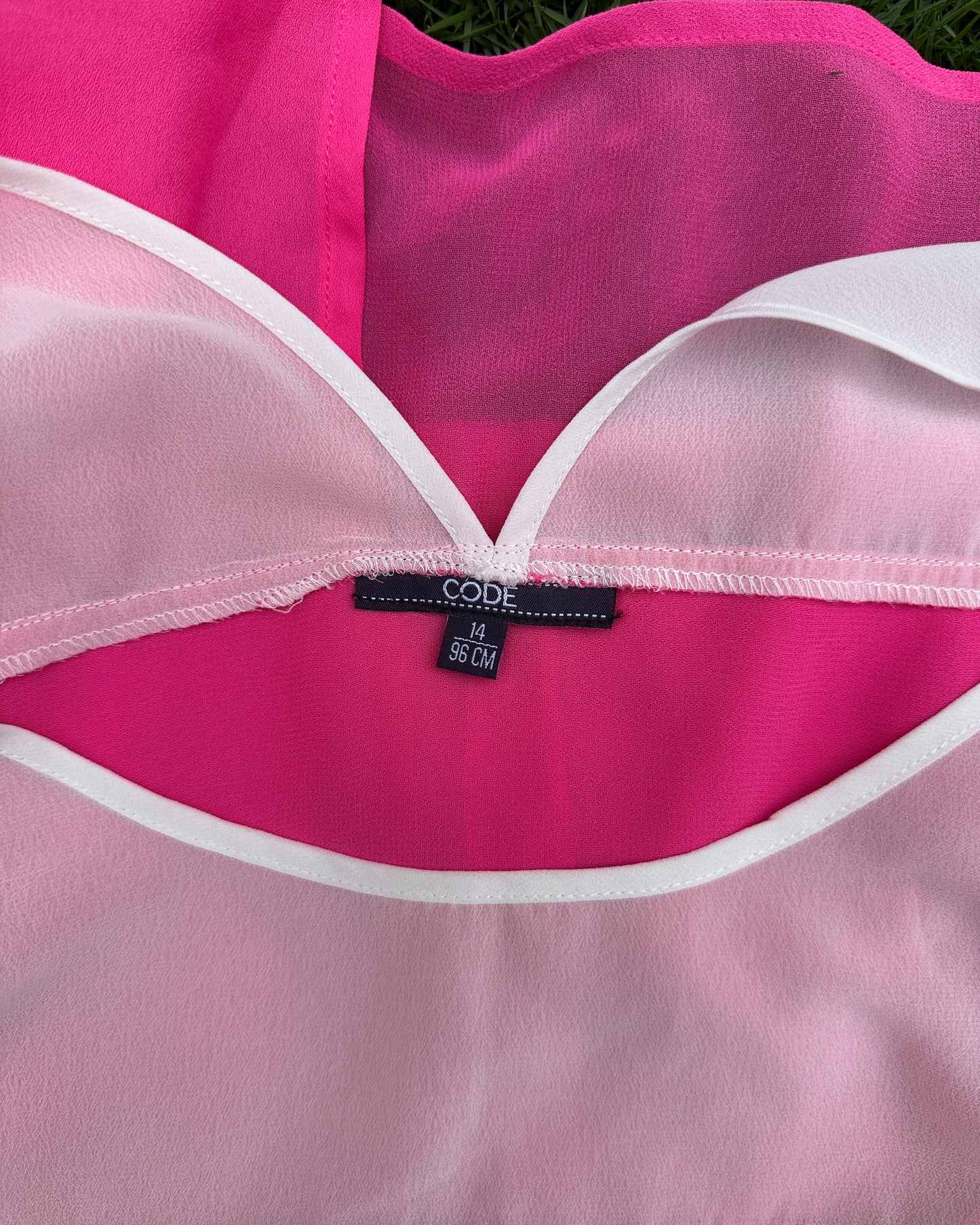 White and pink top with metal eyelets