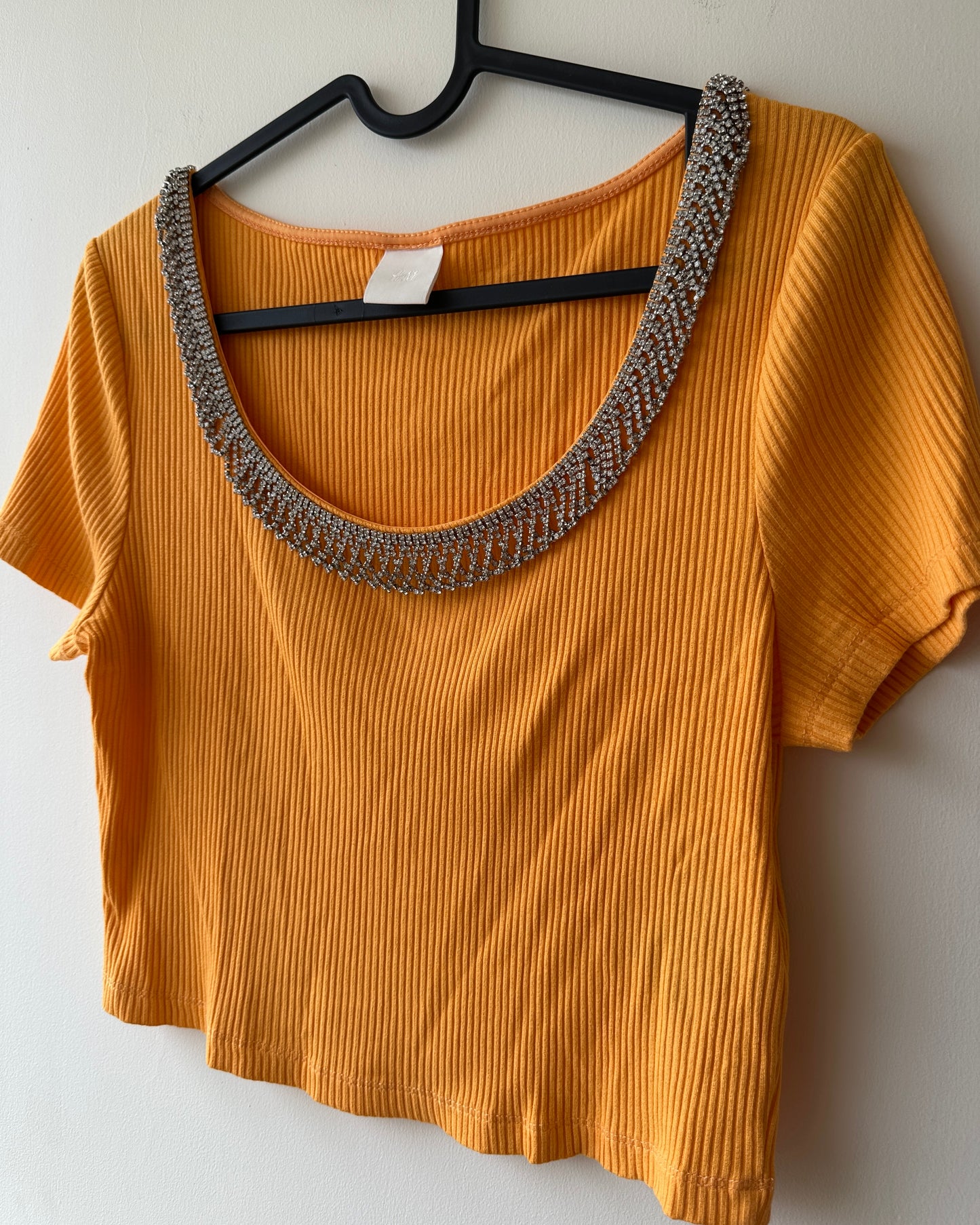Orange knit crop top with embellishments