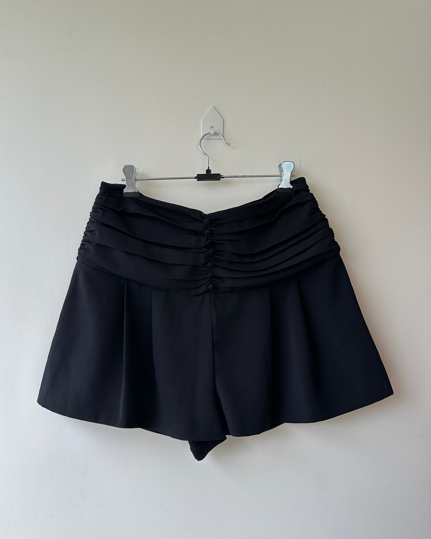 Black pleated high waist shorts with buttons