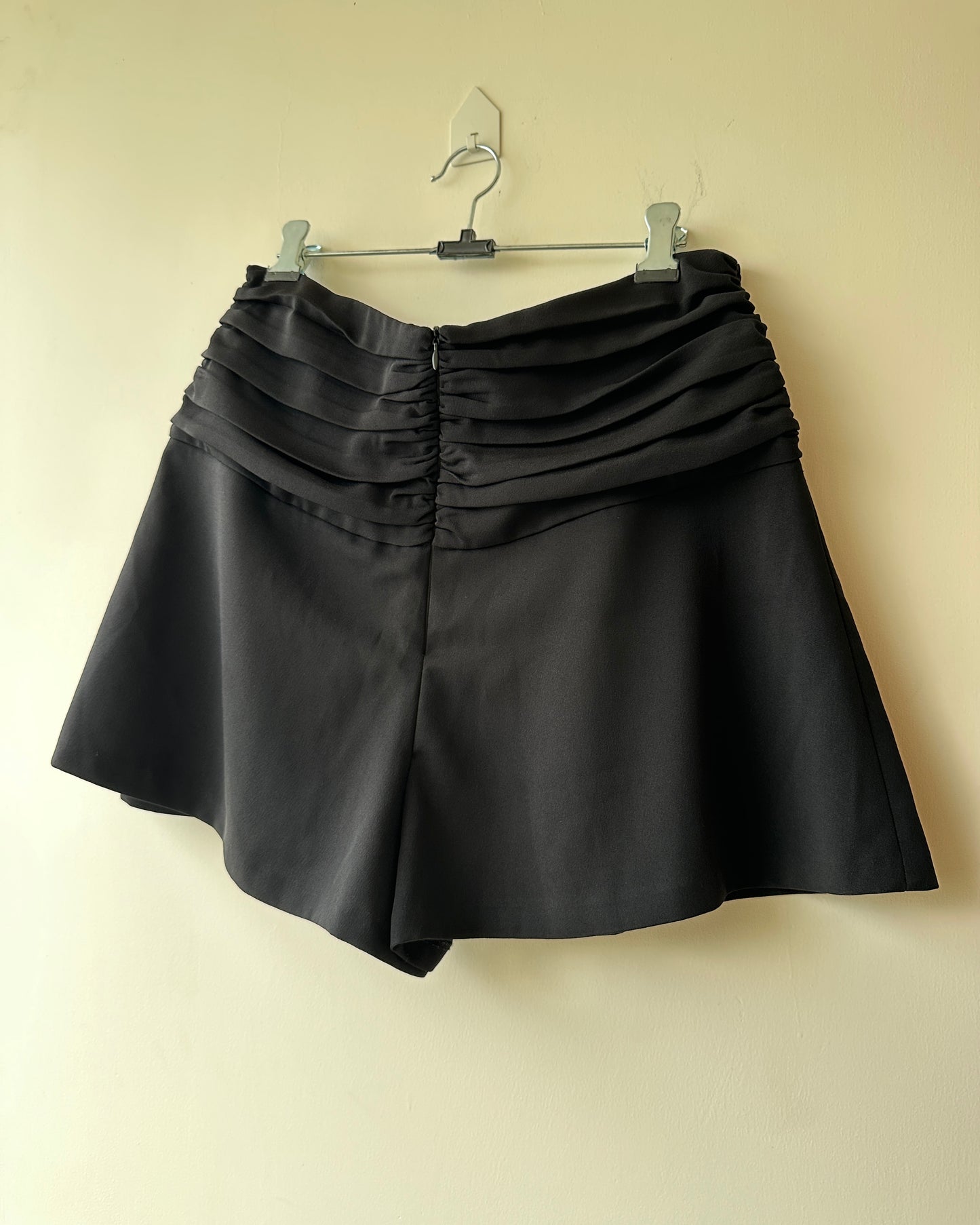 Black pleated high waist shorts with buttons
