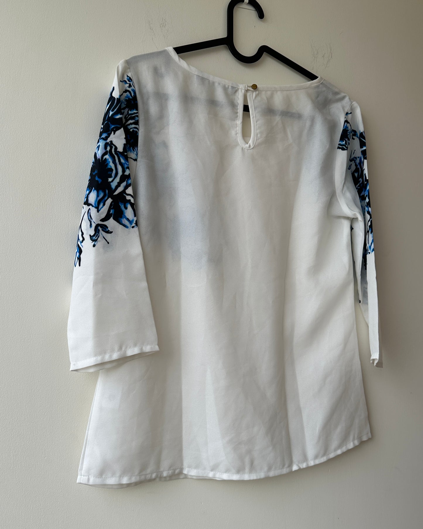 White formal top with blue flowers