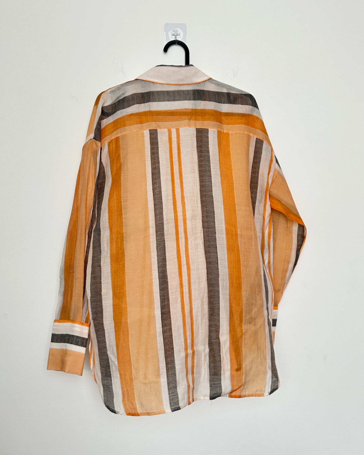 White shirt with black and orange stripes