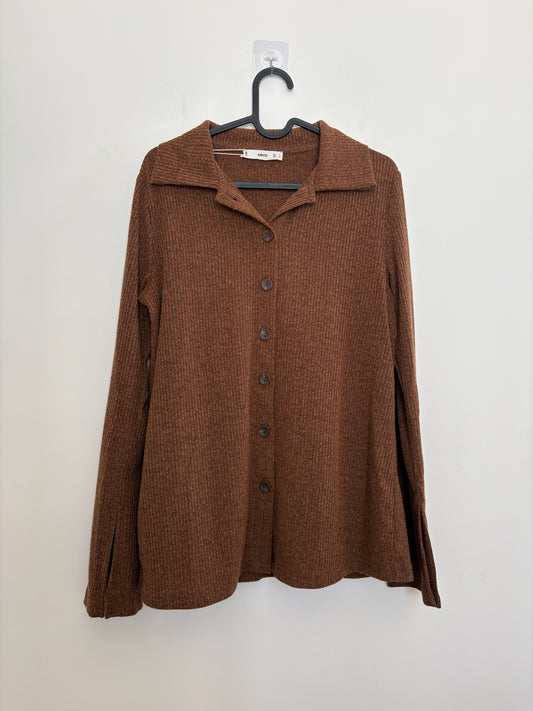 The Circle MNG brown ribbed knit button-down shirt with a polo collar and split-cuff sleeves hanging on a hanger.
