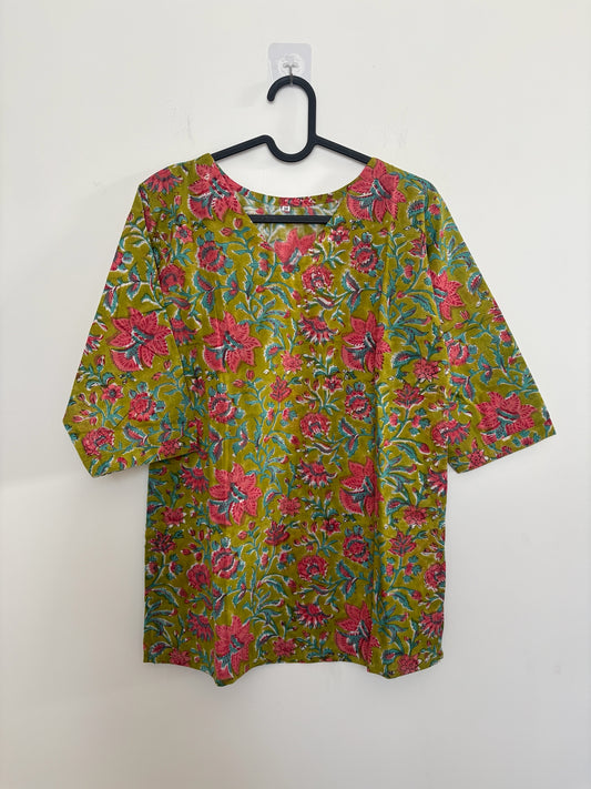 The Circle olive green cotton kurti with pink and teal floral block print, V-neckline, and half sleeves.