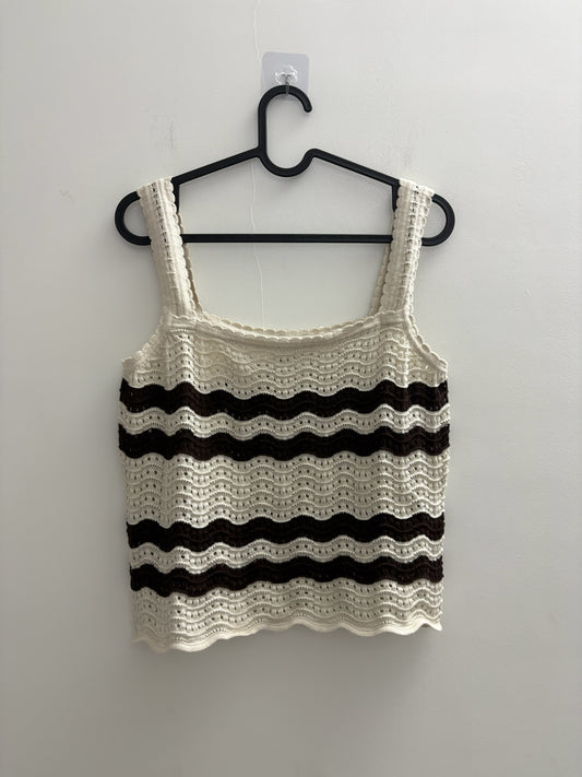 The Circle sleeveless crochet tank top in cream and dark brown with a wave-pattern knit and scalloped edges.