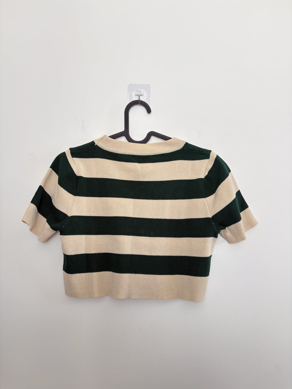 The Circle striped knit short sleeve crop top in forest green and cream with a ribbed crew neckline.