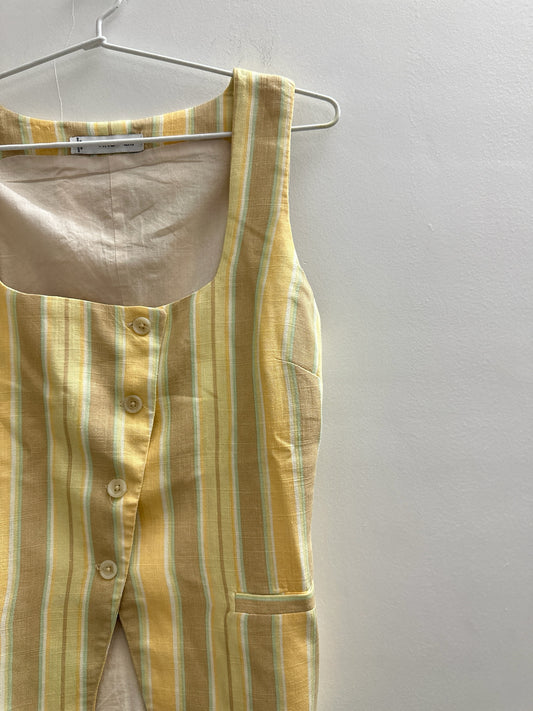 The Circle sleeveless waistcoat in yellow and cream striped linen-blend fabric with a square neckline and buttons.