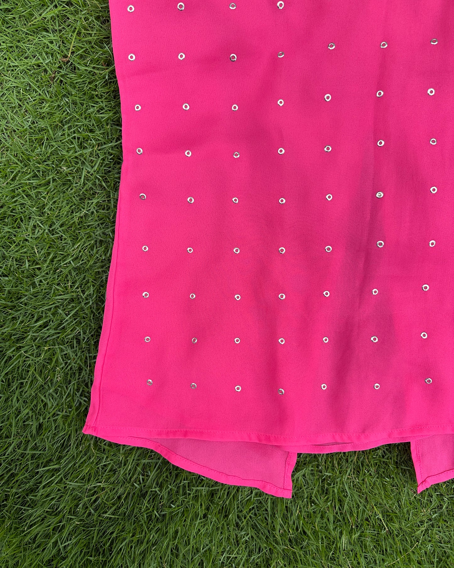 White and pink top with metal eyelets