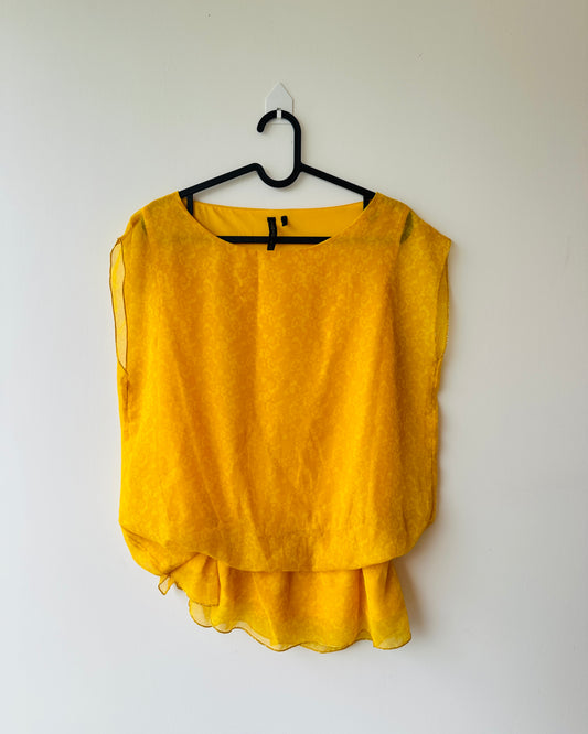 Yellow patterned blouse with asymmetrical hem