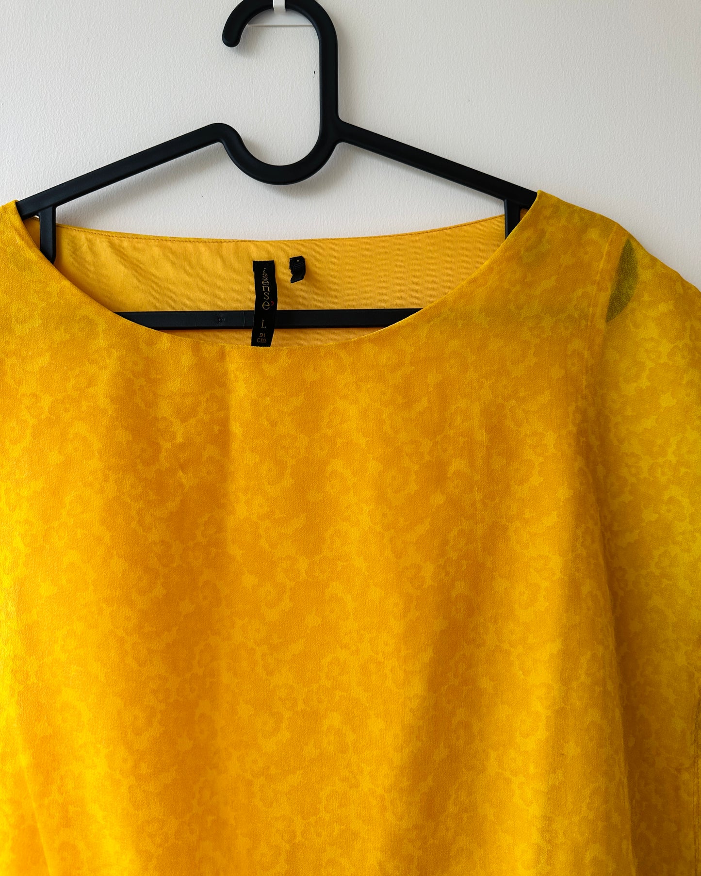 Yellow patterned blouse with asymmetrical hem