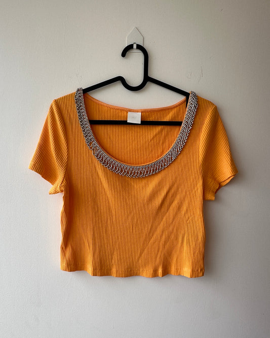 Orange knit crop top with embellishments