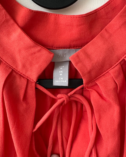 Orange top with flutter sleeves