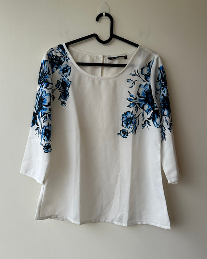 White formal top with blue flowers