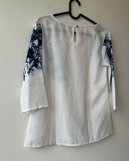 White formal top with blue flowers