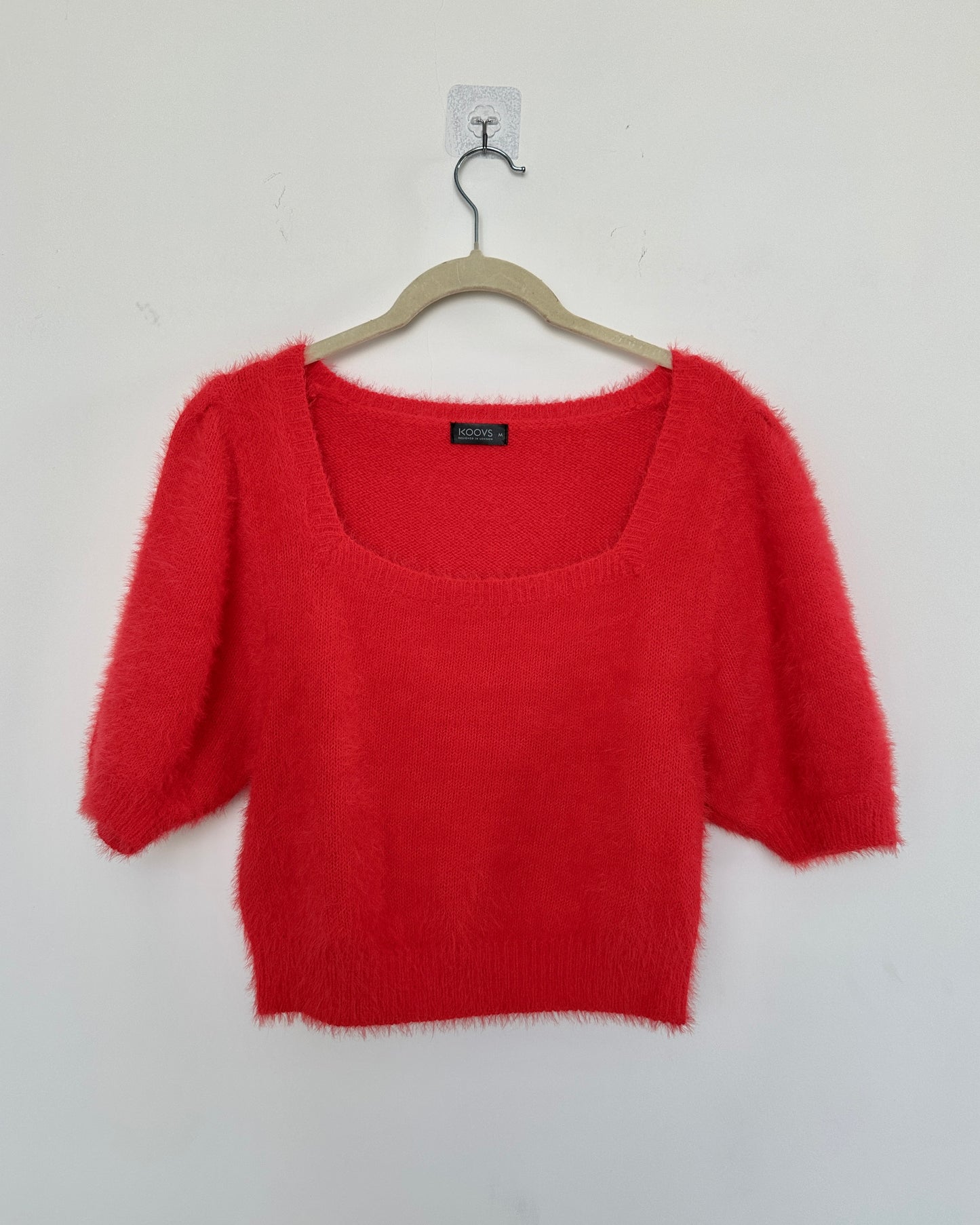 Red knit top with puff sleeves