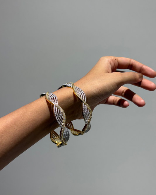 Gold and silver wavy bangles