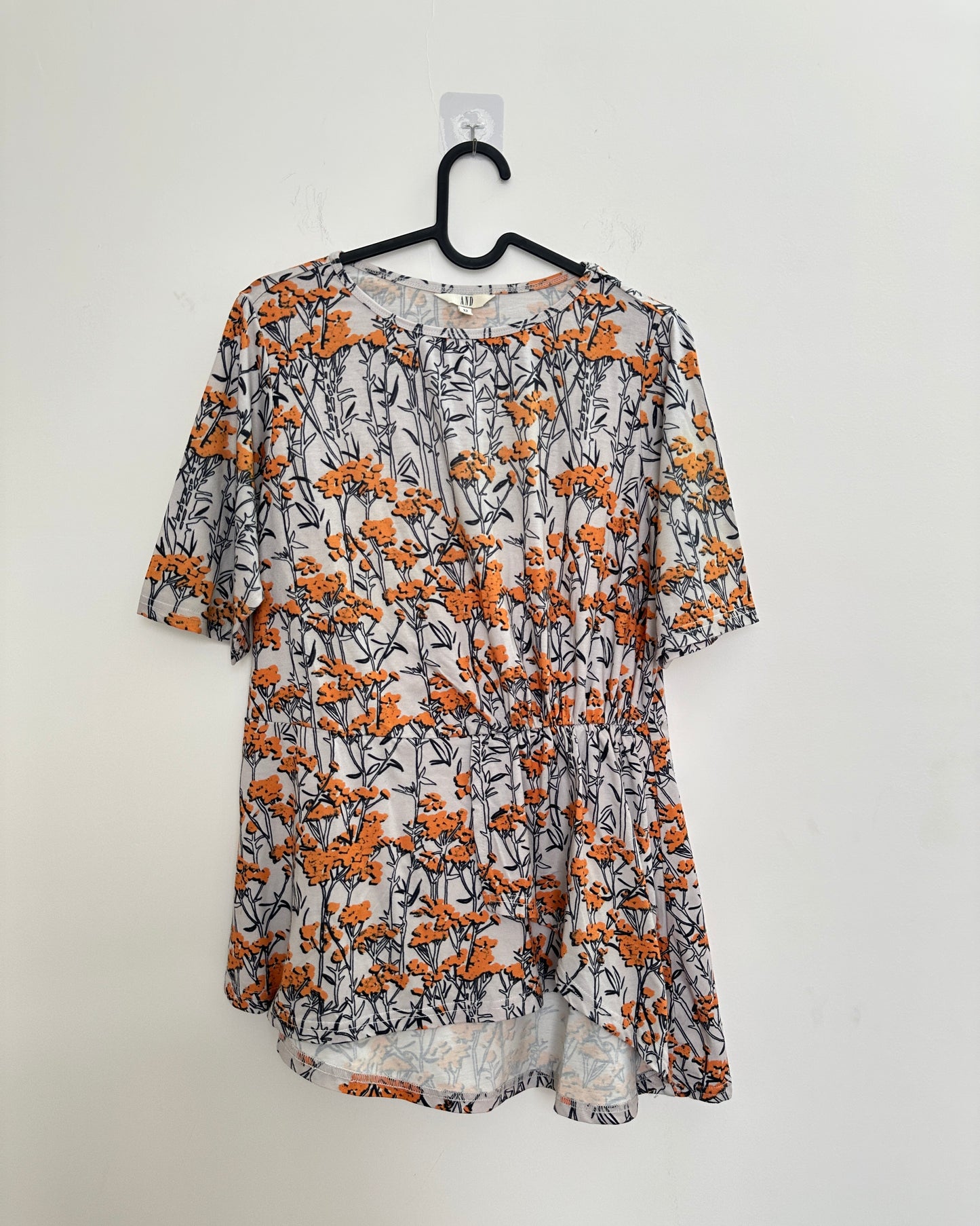 White and orange floral top with asymetric pleats