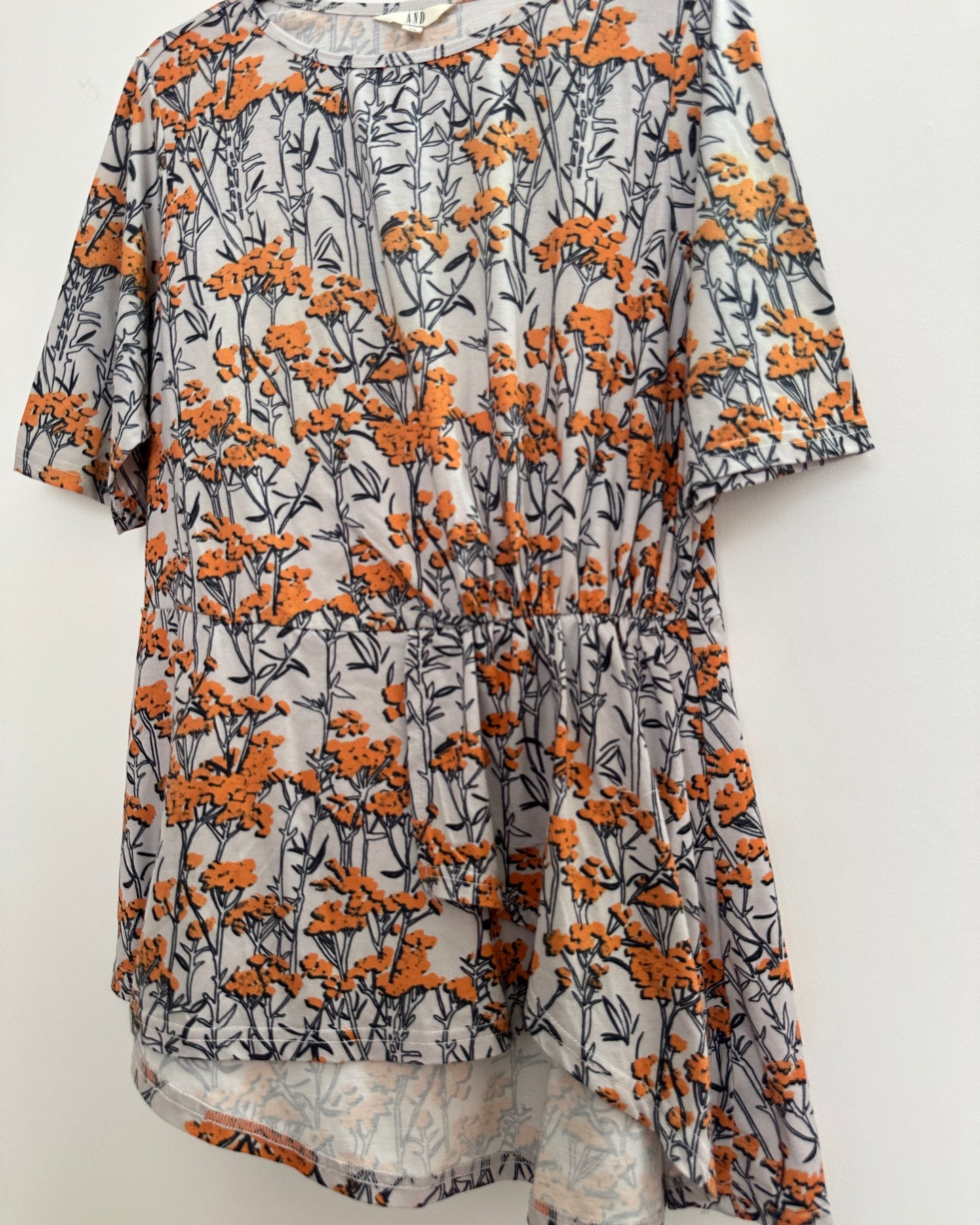 White and orange floral top with asymetric pleats