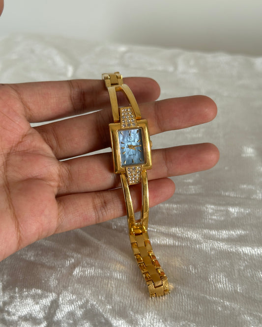 Gold studded watch with blue dial