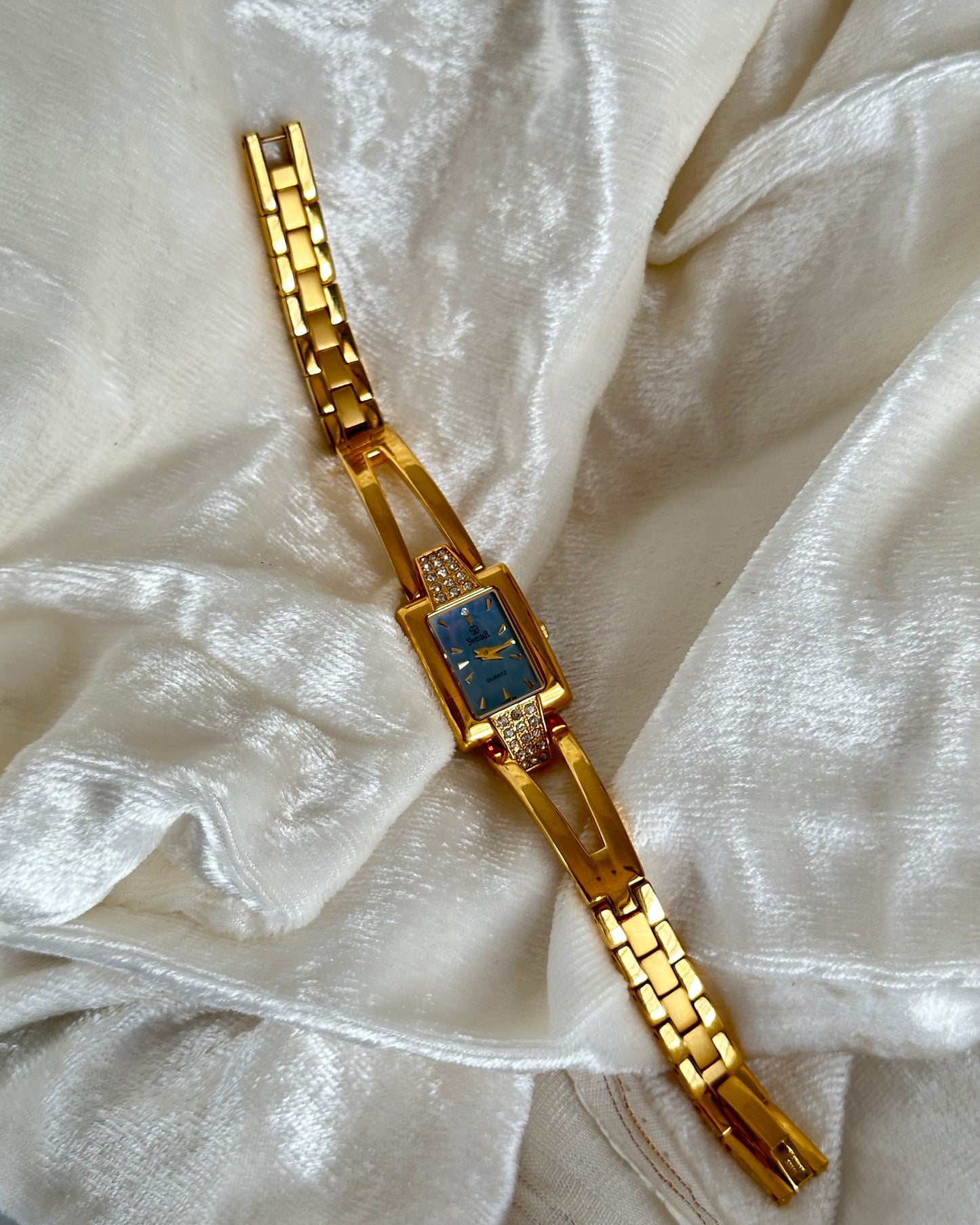 Gold studded watch with blue dial