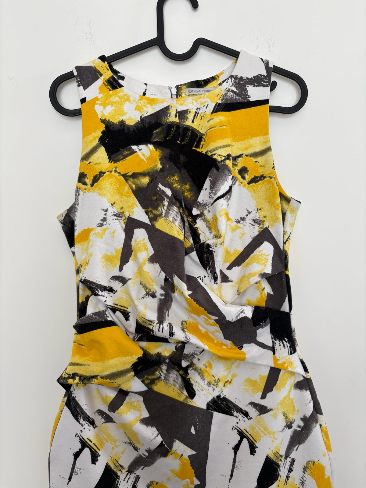The Circle sleeveless sheath dress featuring a mustard yellow, charcoal grey, and white abstract brushstroke print.