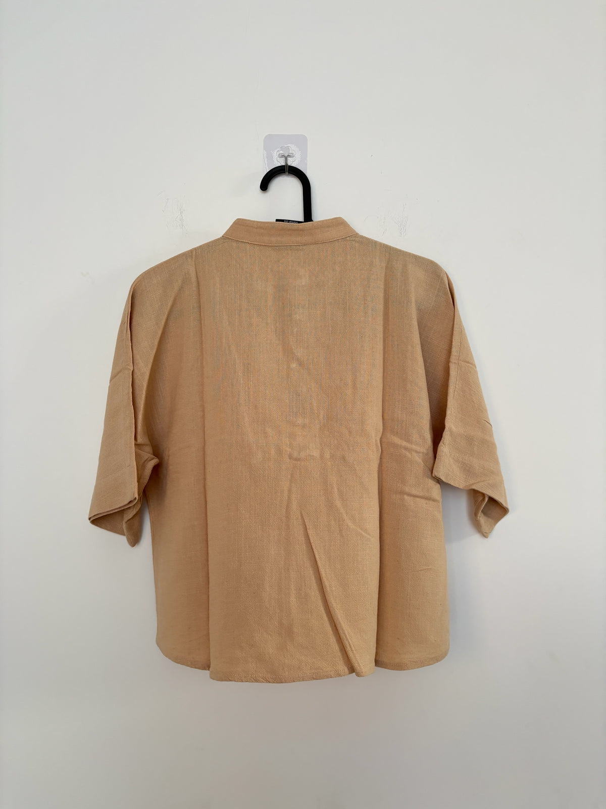 The Circle beige linen-blend boxy top with a mandarin collar and elbow-length sleeves, shown from the back view.
