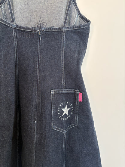 The Circle Betty Jackson Studio dark denim midi dress featuring a back zip, white topstitching, and a star logo pocket.
