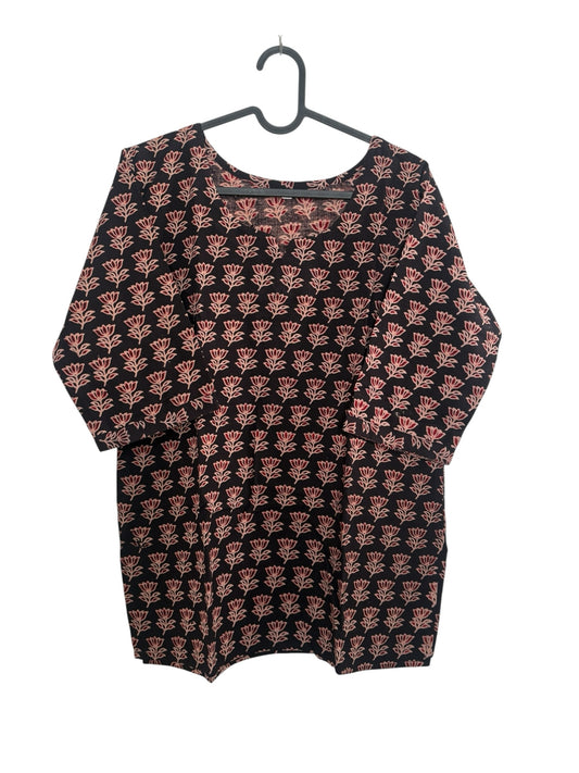The Circle black cotton kurti featuring a delicate pink floral block print, round neckline, and three-quarter sleeves.