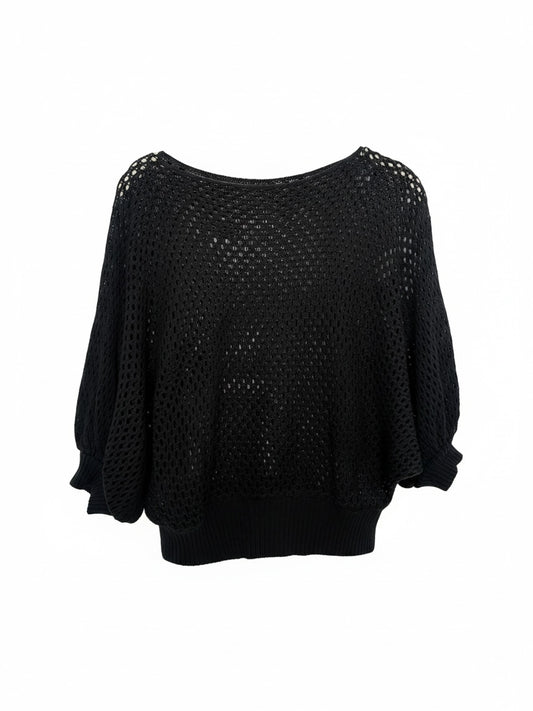 The Circle black loose knit pullover sweater featuring an airy open-knit texture, batwing sleeves, and ribbed hem.