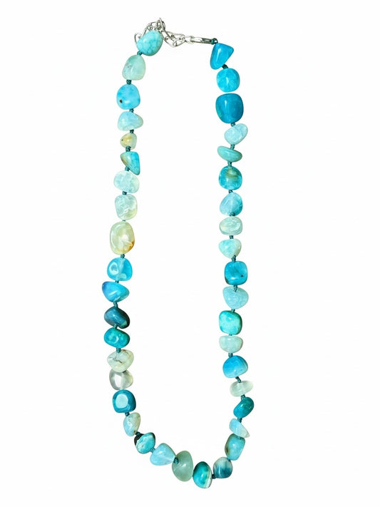 The Circle handcrafted necklace featuring polished blue agate stones in varying shades with a silver-toned clasp.