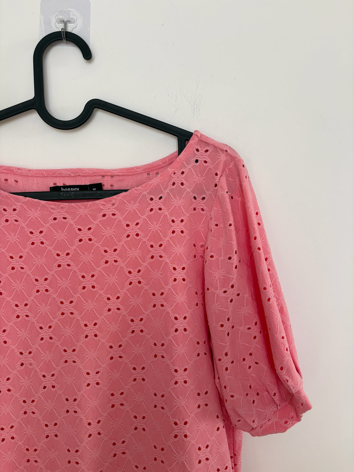 The Circle bossini pink eyelet embroidered casual top with round neckline and puff sleeves on a black hanger