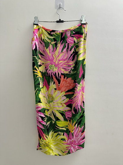 The Circle floral print midi skirt with vibrant pink, yellow, and coral botanical patterns on a black background.