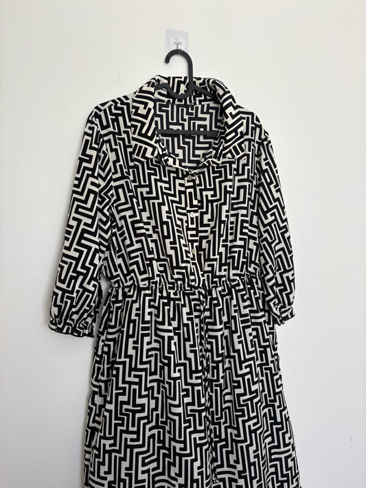 The Circle black and white geometric print midi dress with a button-down front, shirt collar, and three-quarter sleeves