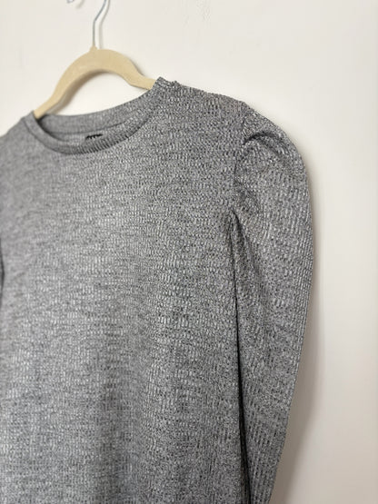 The Circle grey knit pullover top featuring a crew neckline and dramatic puff sleeves on a hanger.