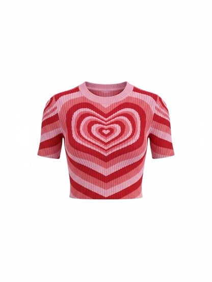 The Circle short sleeve knit crop top featuring a bold pink and red concentric heart pattern and ribbed texture.