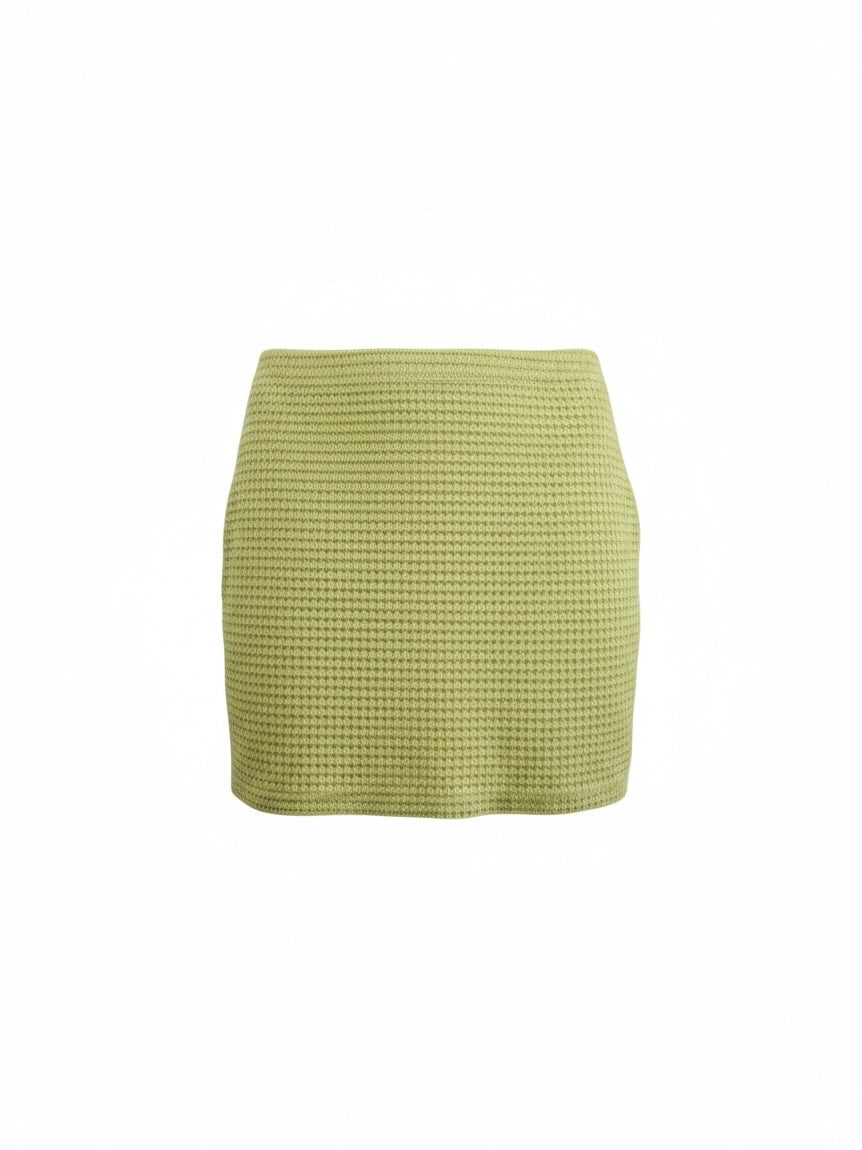 The Circle lime green mini skirt in a textured waffle-knit fabric with a form-fitting silhouette.