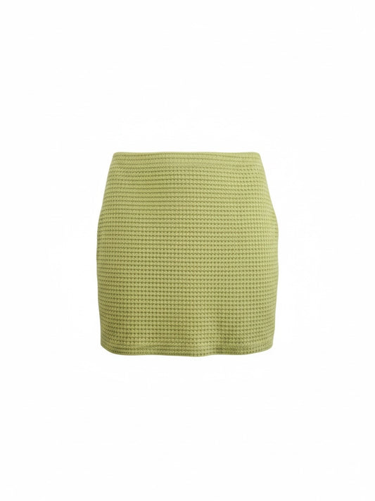 The Circle lime green mini skirt in a textured waffle-knit fabric with a form-fitting silhouette.