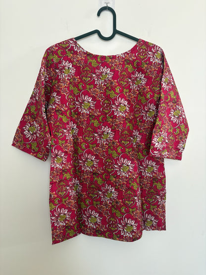 The Circle magenta cotton kurti featuring a vibrant floral block print with intricate kantha-style quilting details.