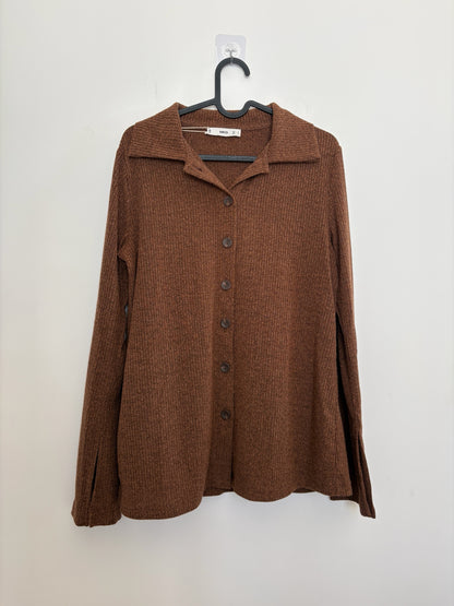 The Circle MNG brown ribbed knit button-down shirt with a polo collar and split-cuff sleeves hanging on a hanger.