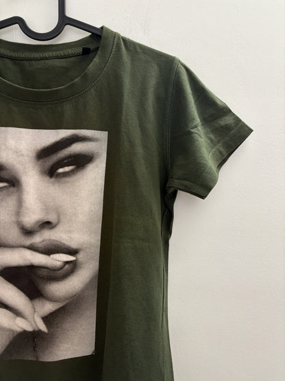 The Circle olive green crew neck t-shirt featuring a black and white photographic print of a woman's face.