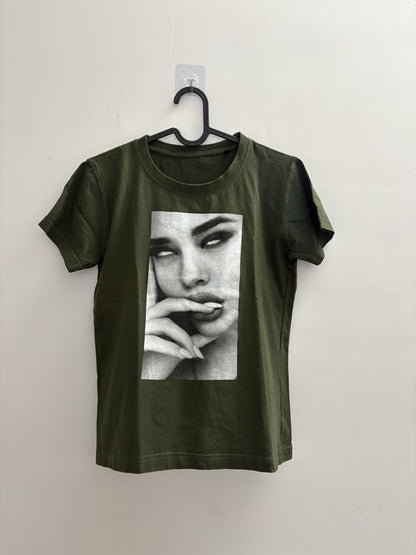 The Circle olive green crew neck t-shirt featuring a black and white photographic print of a woman's face.