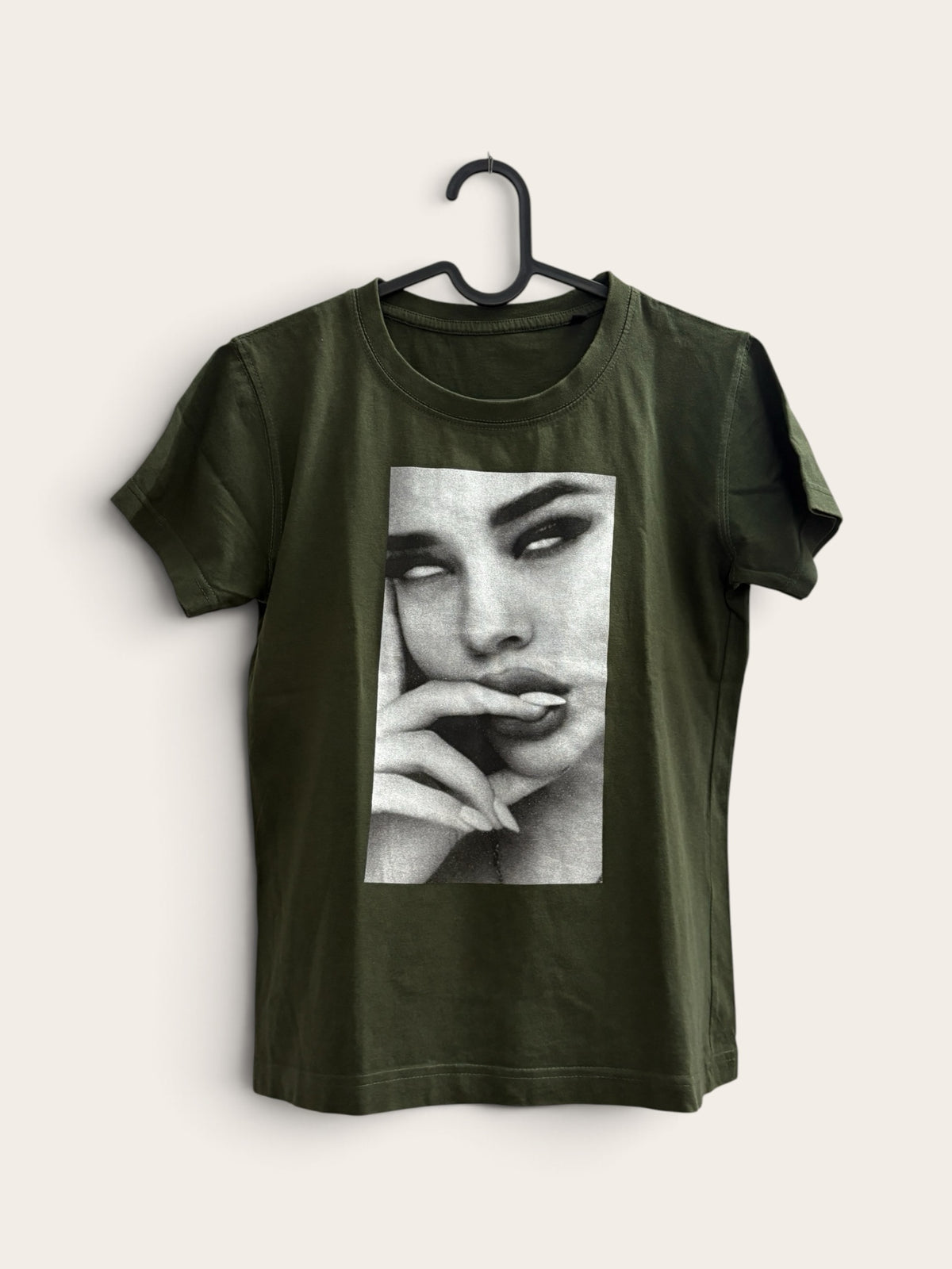 The Circle olive green crew neck t-shirt featuring a bold black and white photographic face print on soft cotton