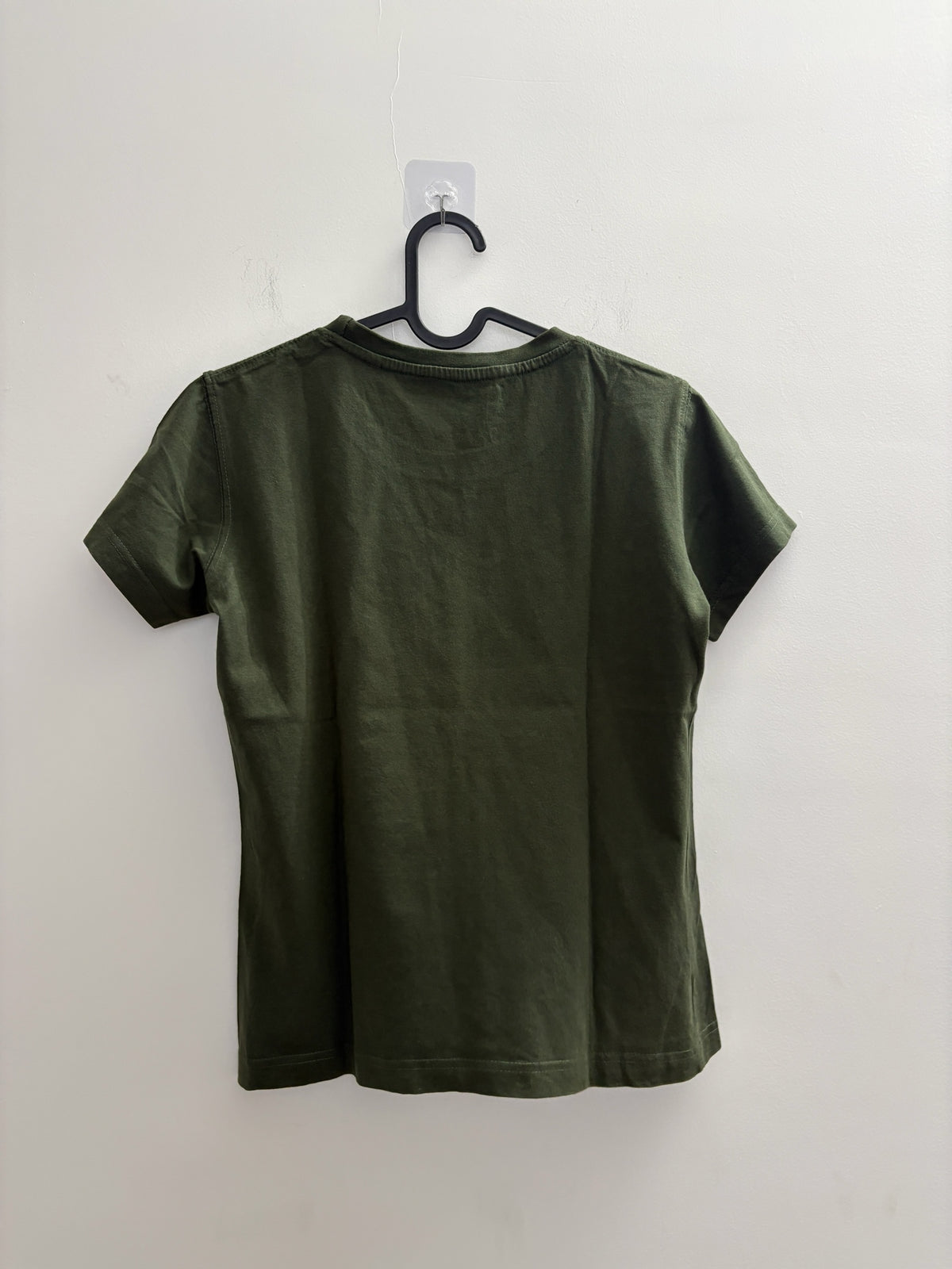Back view of The Circle olive green crew neck t-shirt in soft cotton-blend fabric hanging on a black hanger.