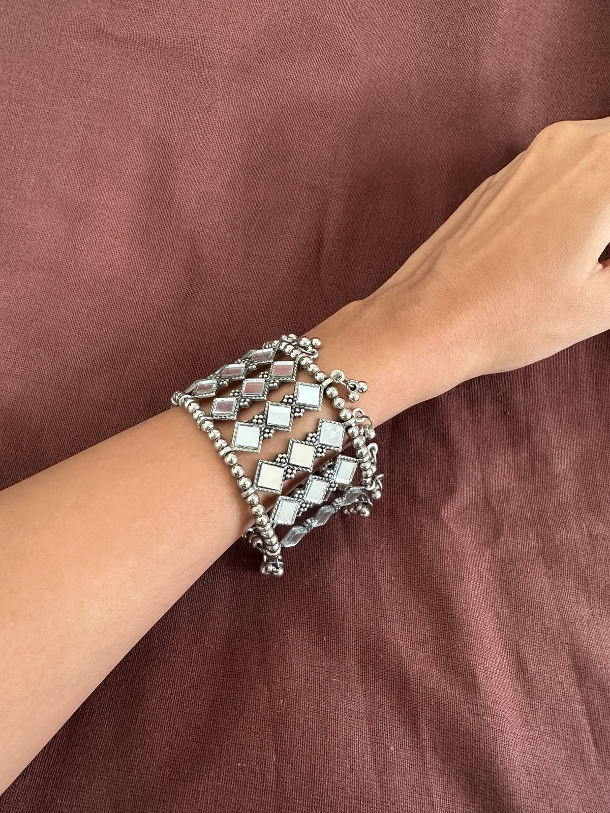 The Circle handcrafted oxidised silver cuff bracelet featuring square mirror work and delicate beadwork on a wrist