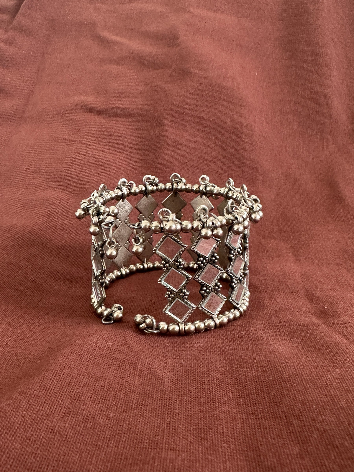 The Circle handcrafted oxidised silver cuff bracelet featuring an intricate lattice pattern with square mirror work.