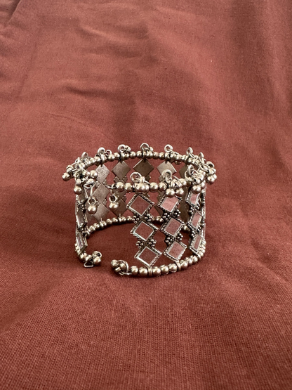 The Circle handcrafted oxidised silver cuff bracelet featuring an intricate lattice pattern with square mirror work.