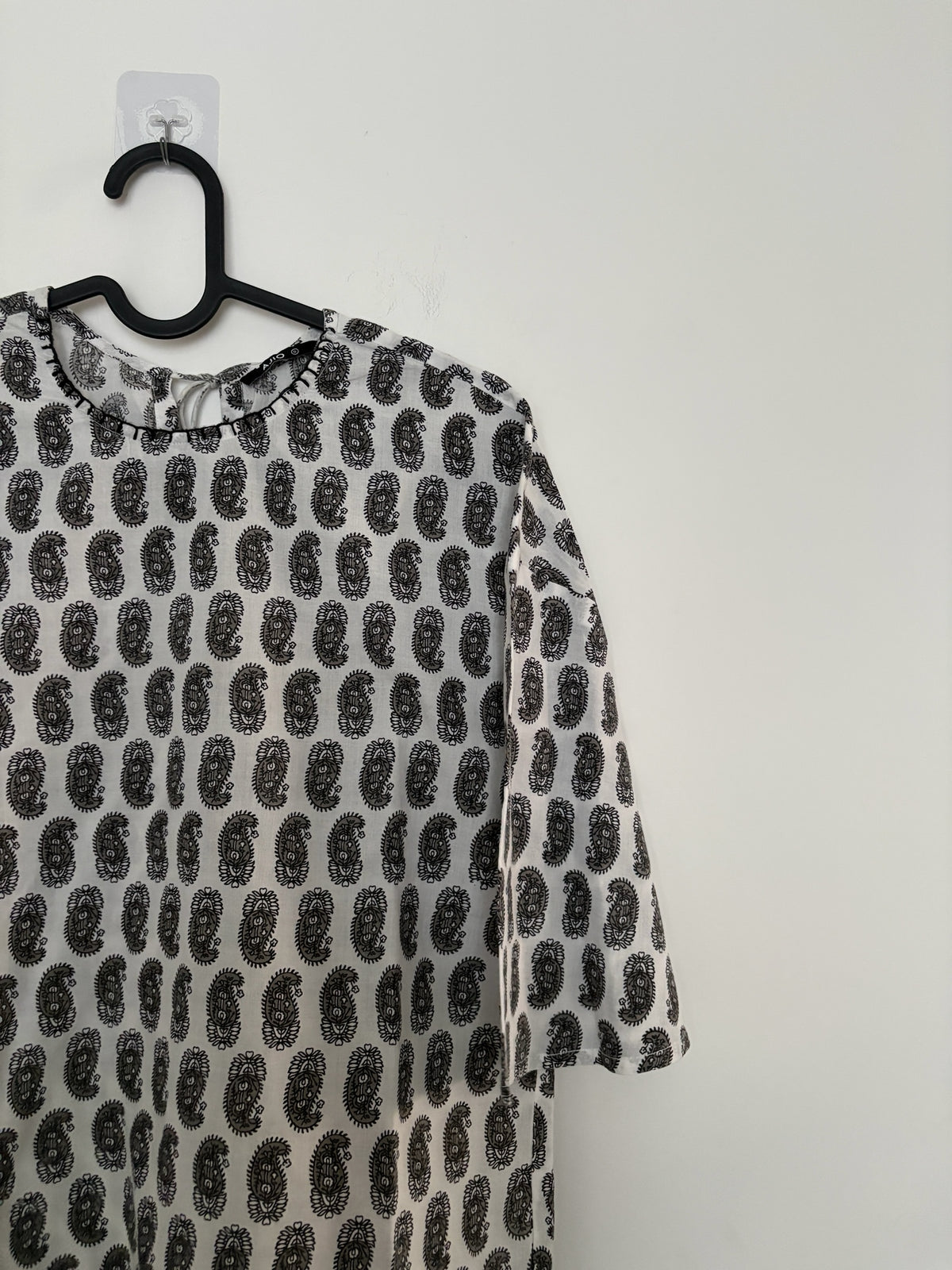 The Circle monochrome paisley print round neck top with three-quarter sleeves and back tie-up detail.
