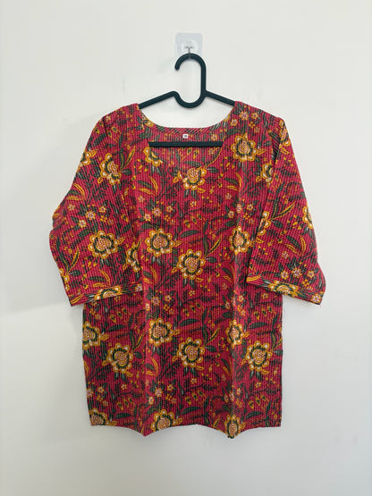 The Circle red cotton kurta featuring yellow and green floral block prints and delicate vertical kantha stitching.