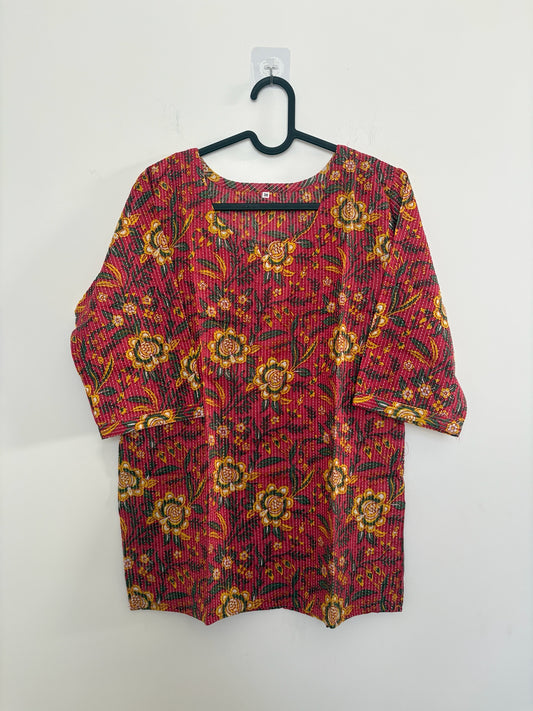 The Circle red cotton kurta featuring yellow and green floral block prints and delicate vertical kantha stitching.